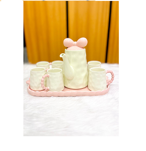 Cute porcelain tea set with lid, consisting of one teapot, four cups, and one tray
