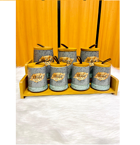 Set of 7-piece porcelain spice jars with stone gray coating and embossed leaf patterns equipped with wooden lids with modern leather handles and matching wooden tray 
