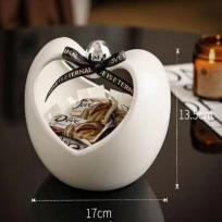 Porcelain bonbonniere, neutral color, features an elegant apple design and adds a decorative touch to your home.
