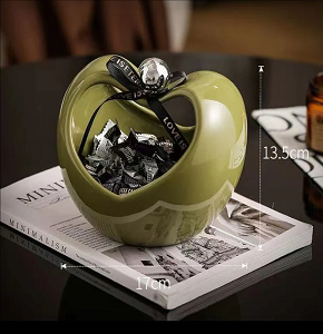 Porcelain bonbonniere, lime green, features an elegant apple design and enhances your home décor.

