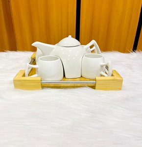 Porcelain tea set consisting of teapot plus 4 porcelain mugs with wooden tray 
