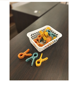 Set of strong plastic laundry clips with bright colors and basket