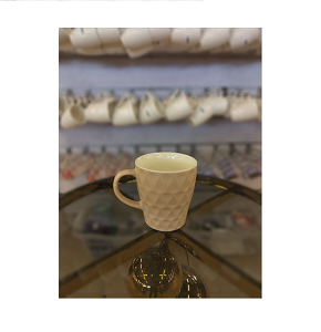 Elegant porcelain mug with textured surface and comfortable handle 
