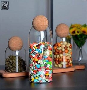 “A set of 3 pieces of plain glass with a wooden ball cover
