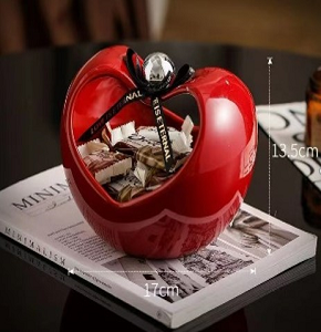 Porcelain bonbonniere, glossy red, features an elegant apple design and adds a stylish touch to your home décor.

