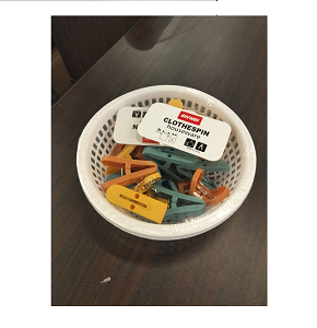 Set of strong durable plastic laundry clips with bright colors and basket