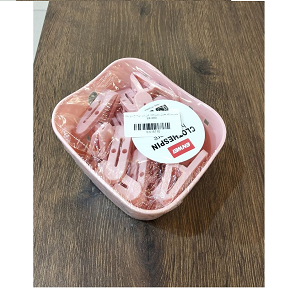 Set of light pink plastic laundry clips with basket 
