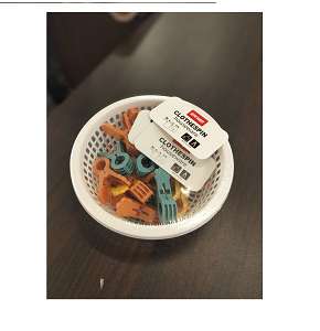 Set of classic laundry clips with practical design and warm earthy colors with basket