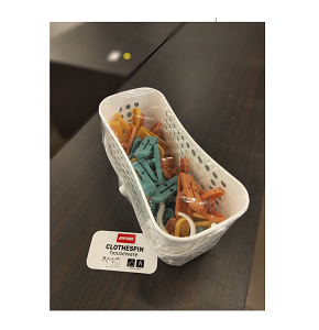 Set of colorful plastic laundry clips with basket