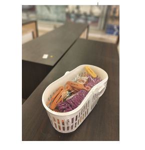 Set of colorful plastic laundry clips with basket and washing rope