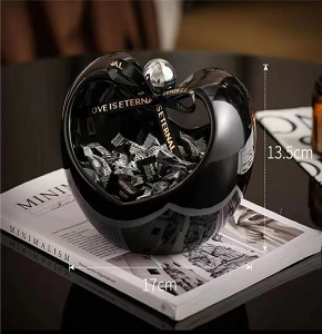Porcelain bonbonniere, glossy black, features an elegant apple design and adds a stylish touch to your home décor.

