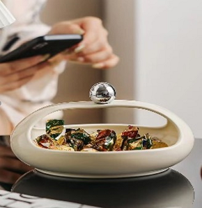 Bonbonniere, neutral color, oval shape with a modern hollow design, perfect for serving sweets.
